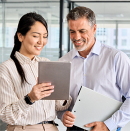 co-workers look at electronic tablet