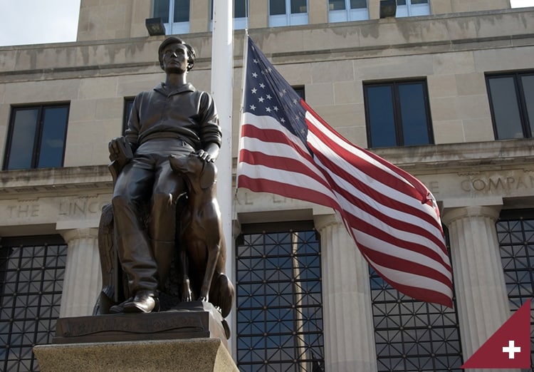 American flag flies next to statue of young Abe Lincoln outside Lincoln Financial building in Ft. Wayne, IN