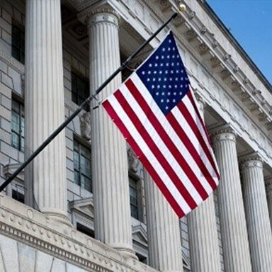 American flag hangs outside building