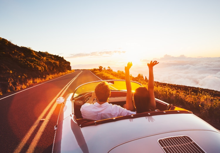 couple driving a car off into the sunset