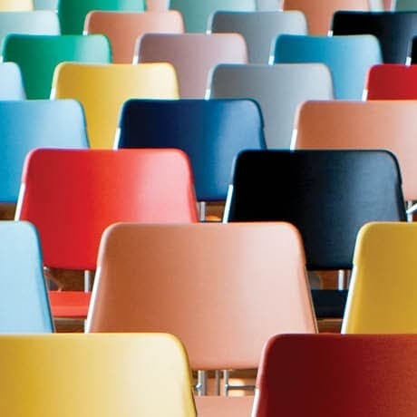 Colorful chairs arranged on risers