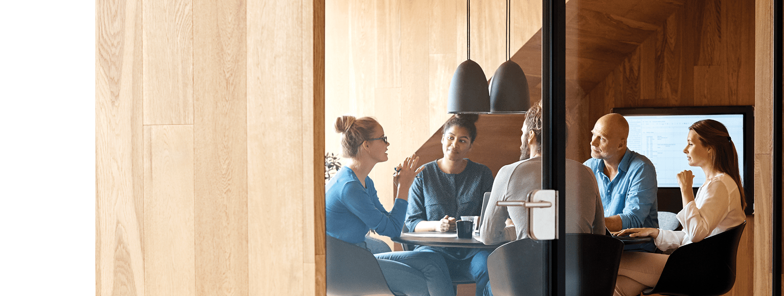 Group of people having a discussion in a conference room.
