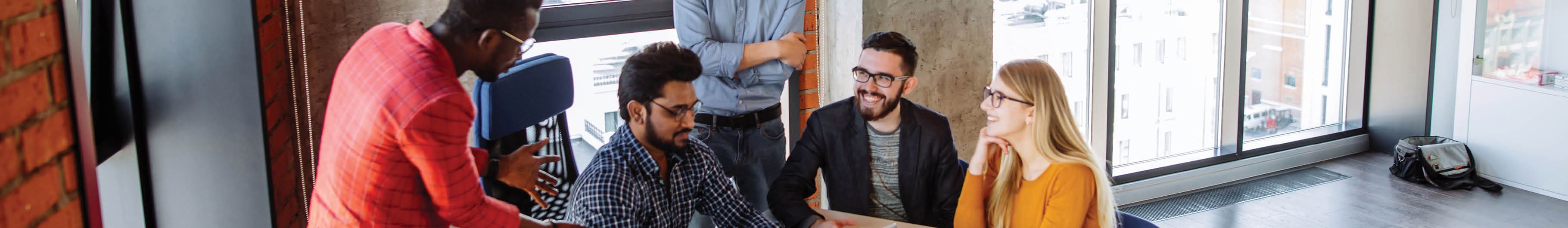 Smiling young professionals in office setting. 