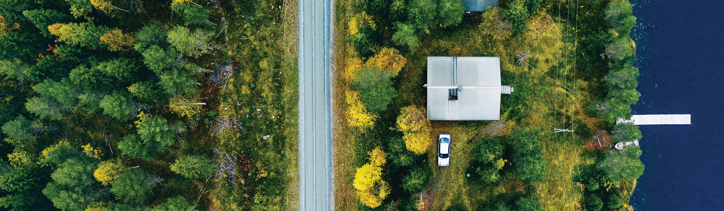 Image of aerial view of grassy area, road and water.