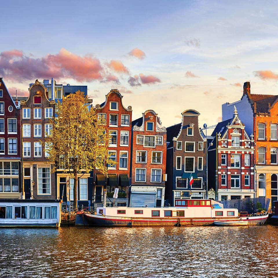 Image of row houses, boats and water.