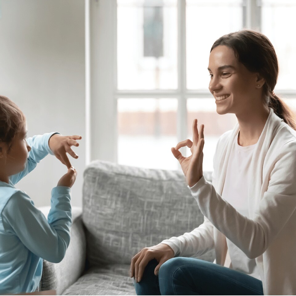 Image of woman signing to child.