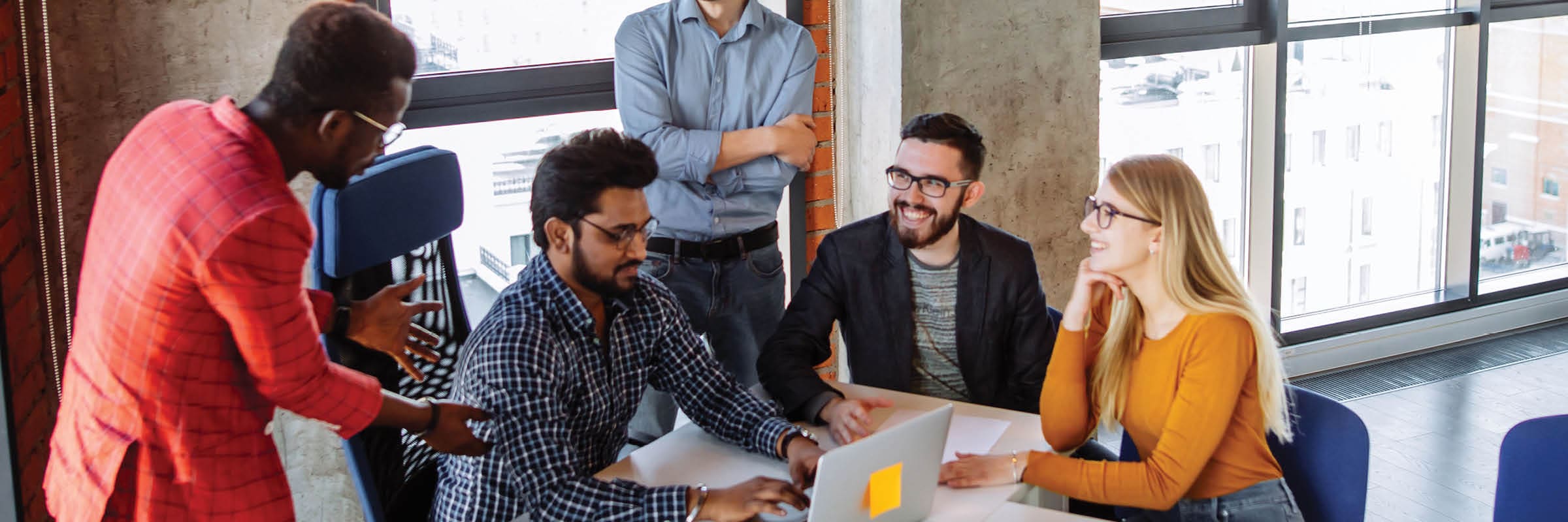 Smiling young professionals in office setting. 