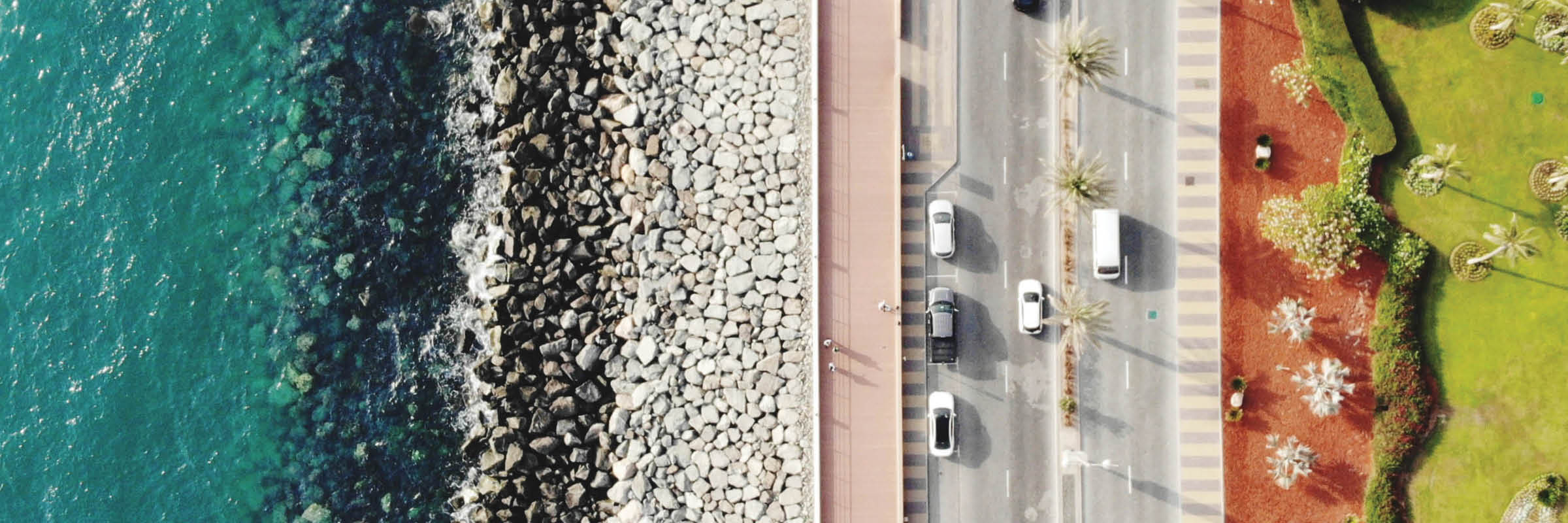 Image of aerial view of water, road and grassy area. 