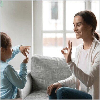 Image of woman signing to child.