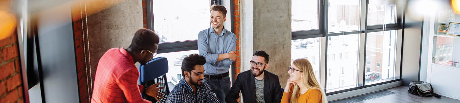 Image of smiling young professionals in office setting. 