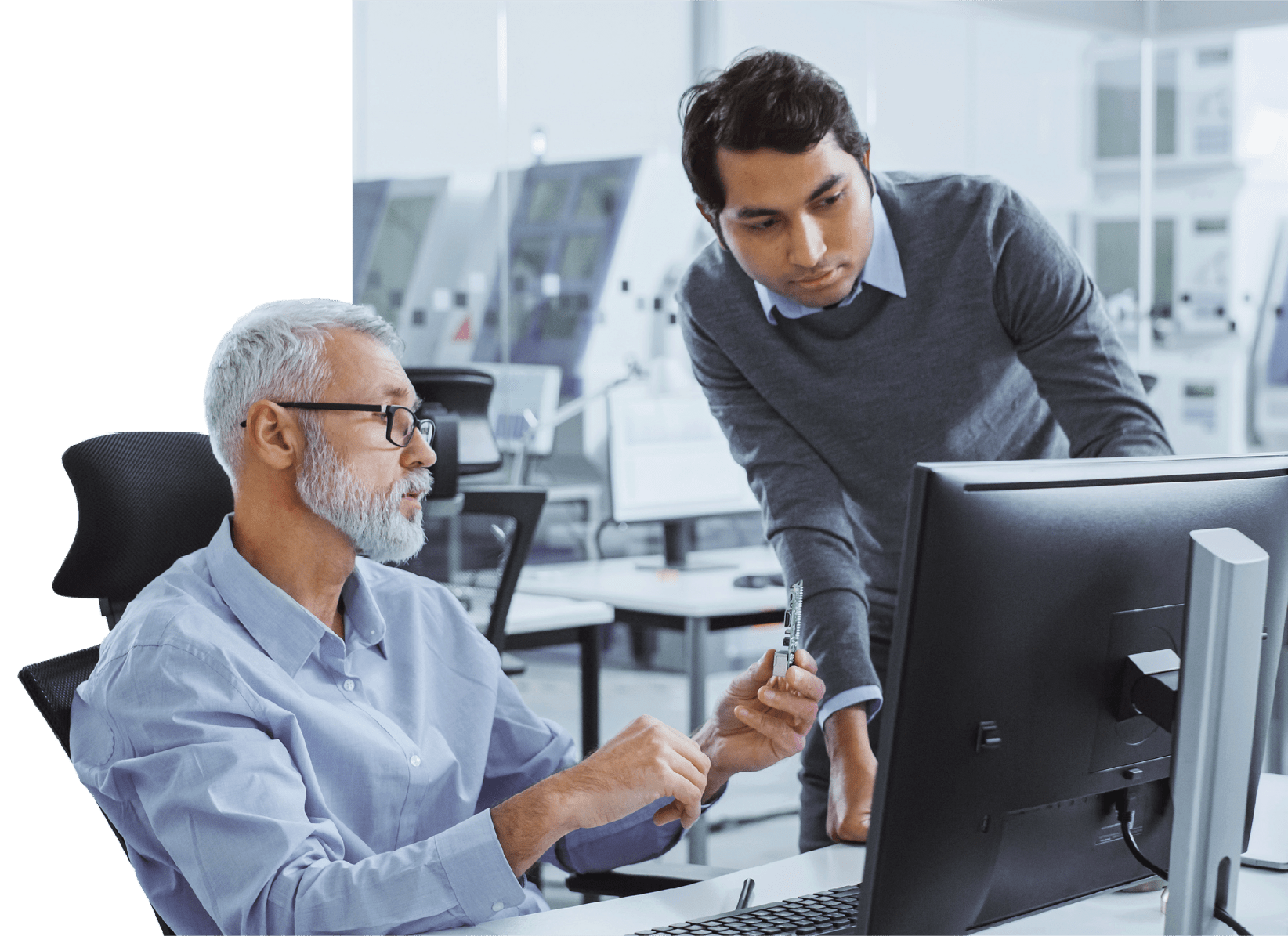 Two men working together on cybersecurity at a computer