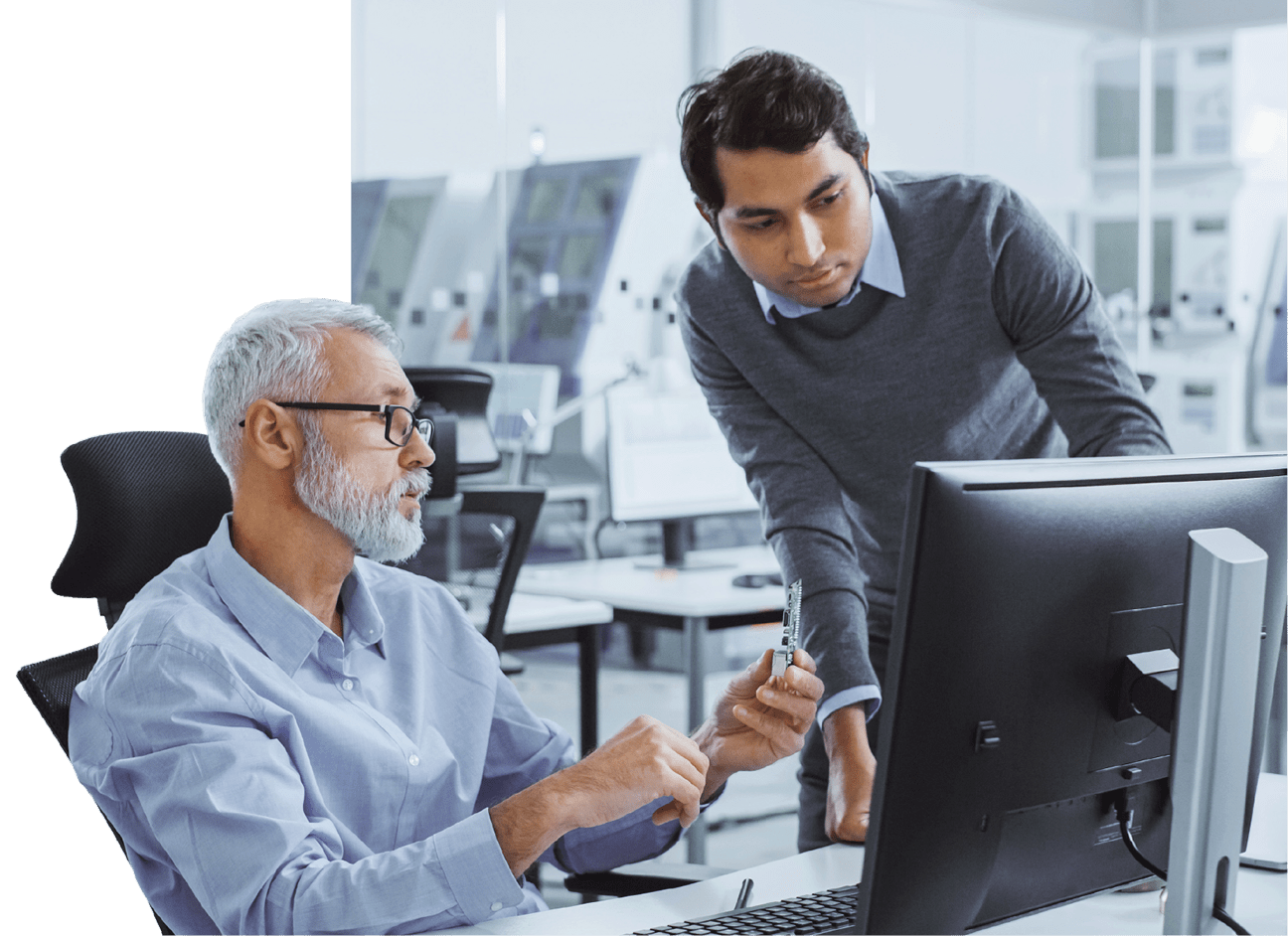 Two men working together on cybersecurity at a computer