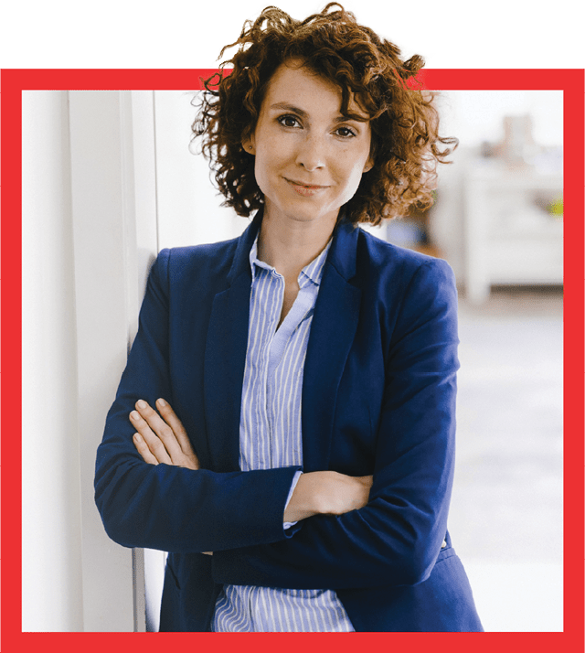 businesswoman leaning against wall with arm crossed