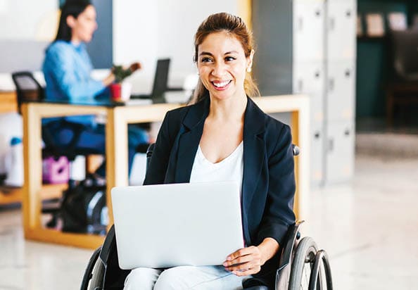 woman in wheelchair with a laptop